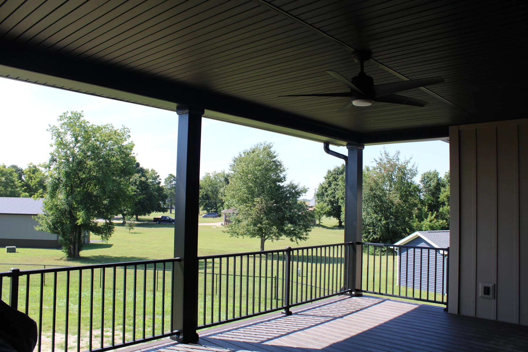 Covered deck with dark railing at a Shorehome Kentucky project