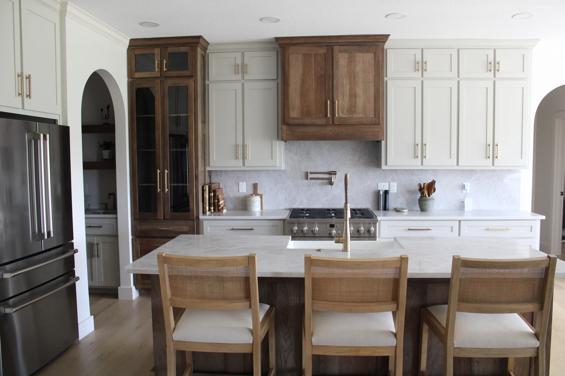 White and warm wood kitchen with a gathering island at a Shorehome Kentucky project